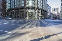 this is an image of an intersection at city streets and buildings along side the road