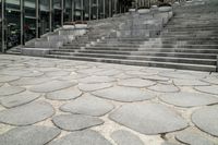 this is a very modern looking area with stone stairs and some concrete steps on the side of the building
