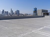 a city with tall buildings is shown in the background and on the ground, there are cars parked on the road