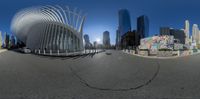 a 360 camera image shows the sun shining in the background in this modern looking city