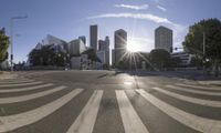 a street with buildings, trees and sunlight in the background that looks like this crosswalk