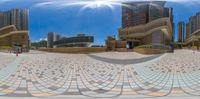 an image of the reflection in a mirror of buildings and walkways in a city