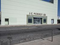 a vacant business on the corner of an empty street with the words jc penney co