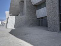 the exterior view of an empty building with many openings and no windows, on a sunny day