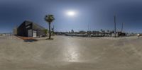 this 360 view is taken from the top of a small hill at sunset time with palm trees and boats in the harbor in the background