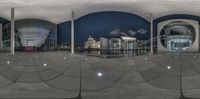 a round - shaped mirror photo of an exterior on the city center in the night