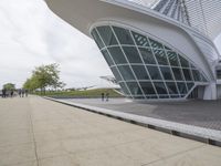 a green building with a very large white window that is on the front of it