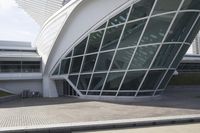 a green building with a very large white window that is on the front of it