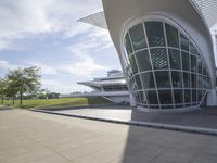 a green building with a very large white window that is on the front of it