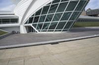 a green building with a very large white window that is on the front of it