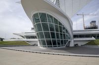 a green building with a very large white window that is on the front of it