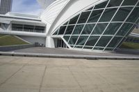 a green building with a very large white window that is on the front of it