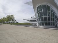 a green building with a very large white window that is on the front of it