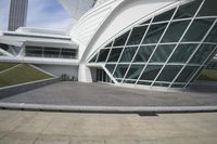 a green building with a very large white window that is on the front of it