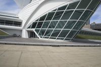 a green building with a very large white window that is on the front of it