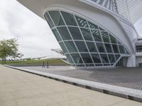 a green building with a very large white window that is on the front of it