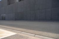 a person wearing a face mask walking across an empty street with a skateboard in the foreground