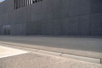 a person wearing a face mask walking across an empty street with a skateboard in the foreground