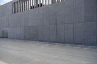 a person wearing a face mask walking across an empty street with a skateboard in the foreground