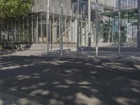 a large glass building with a person walking in front of it on a street in the middle of the day