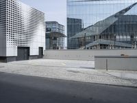 a group of buildings with windows and an architectural roof in the middle of them are glass buildings