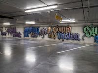 a parking garage with lots of graffiti written on the wall and floors of it,