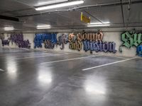 a parking garage with lots of graffiti written on the wall and floors of it,