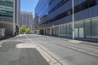 an empty street is empty in front of buildings and buildings in the background are high rise buildings