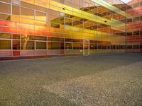 an outside picture of an urban area with orange sky in the background with yellow colored light reflecting off it's windows