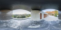 an image of a modern home building through two circular windows in the sky between the round concrete walls