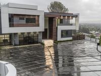 a very nice house by some water in the driveway and on to the stairs to the building