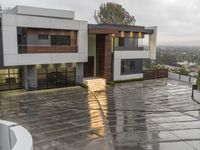 a very nice house by some water in the driveway and on to the stairs to the building