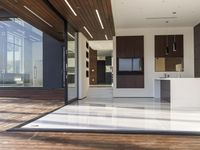 a view out onto the trees of a large modern house in california city, with an outdoor deck with wooden benches and stairs