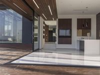 a view out onto the trees of a large modern house in california city, with an outdoor deck with wooden benches and stairs