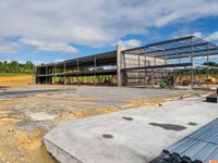 the construction site for a modern house under construction with a long metal pipe on the concrete floor