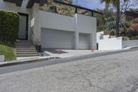 a house with a garage on one side and steps to the other on a steep slope