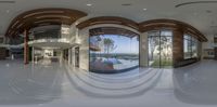 the inside view of a modern house, looking in through glass walls to a balcony