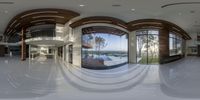 the inside view of a modern house, looking in through glass walls to a balcony