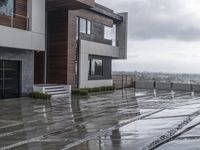 a modern house that has been designed on a steep hillside on a cloudy day with the roof still clear