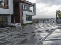 a modern house that has been designed on a steep hillside on a cloudy day with the roof still clear