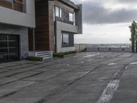 a modern house that has been designed on a steep hillside on a cloudy day with the roof still clear