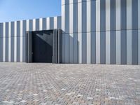 a brick floor and a black gate outside a building for people to see or see