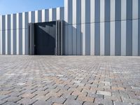 a brick floor and a black gate outside a building for people to see or see