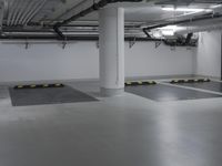 a very empty parking garage with yellow and white lines painted on the floor and ceiling