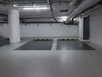 a very empty parking garage with yellow and white lines painted on the floor and ceiling