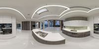 a fish eye view of a kitchen looking at the counter top and fridge below it