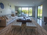 a modern living room has an elegant table in between glass doors and the wall to outside