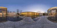 this is a fish eye view of the inside courtyard of a museum and there are a couple trees