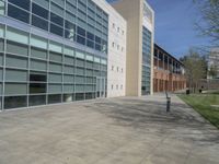 a group of large glass windows sit in front of a brick building and the sky