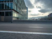 the road is empty on this busy street with the tall building in the background for pedestrians